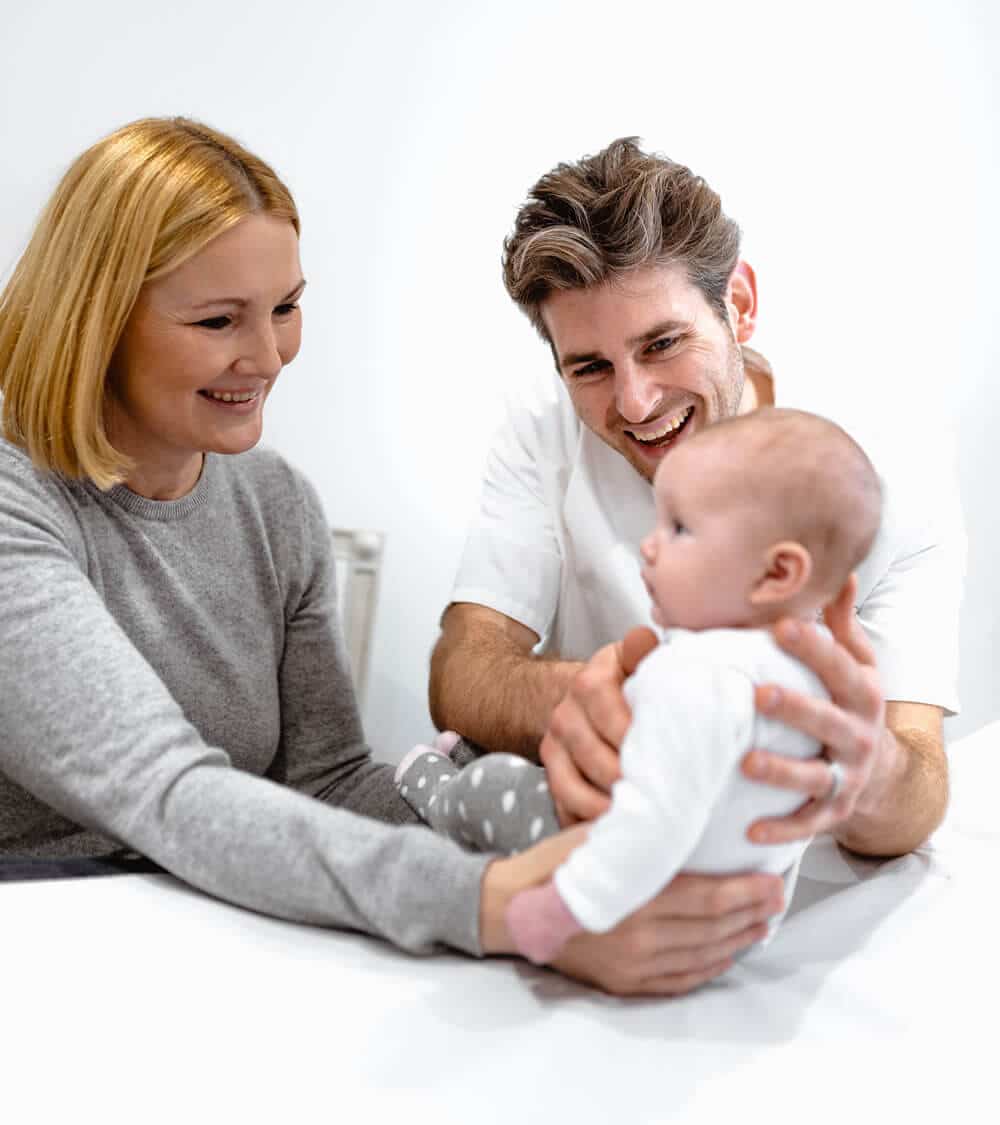 mother and baby having consultation with osteopath ed cossart